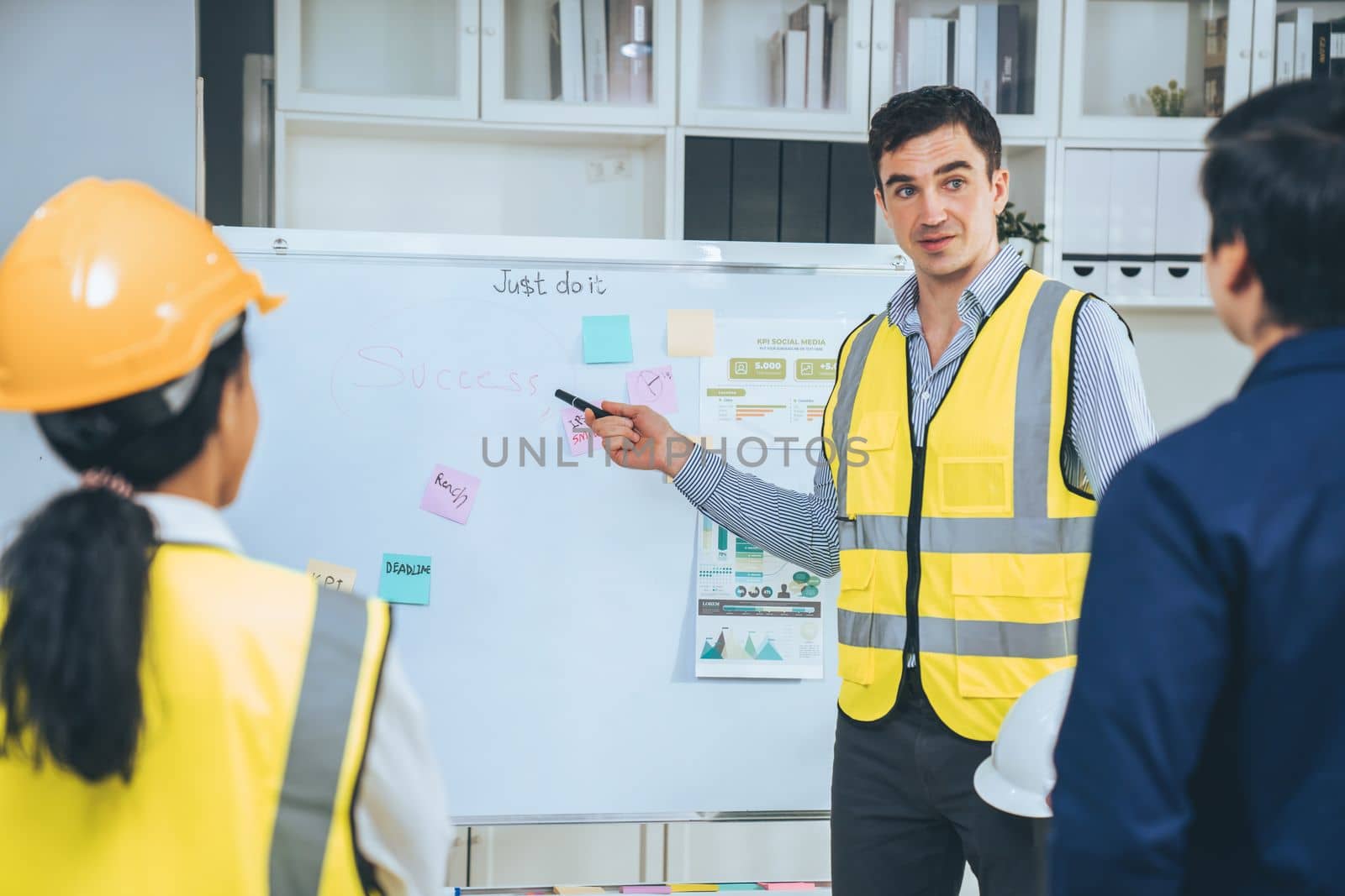 A team of investor and competent engineers brainstorming on the whiteboard to find new ideas and making plans. The idea of a team gather ideas together.