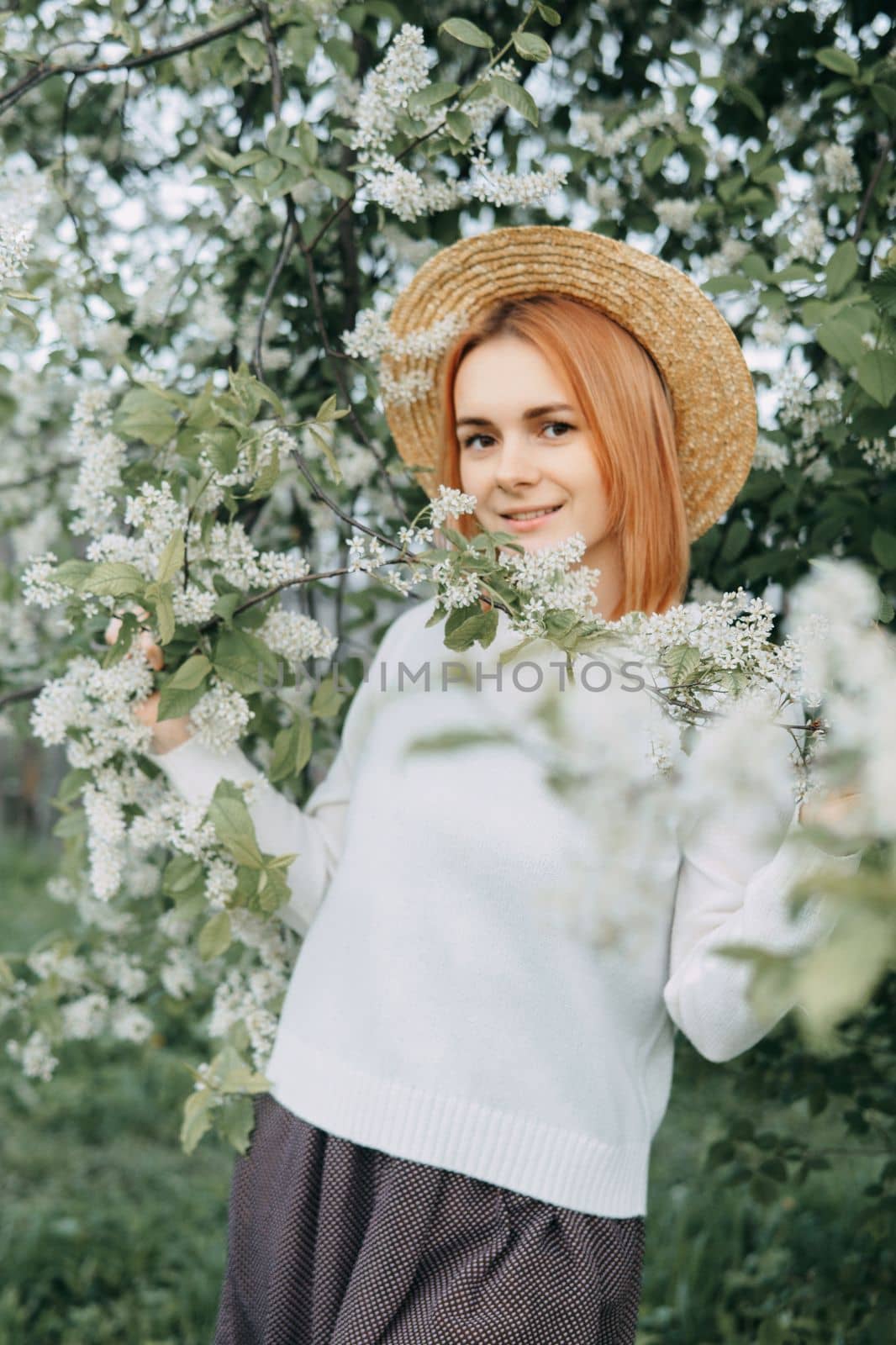 Portrait of a woman in a straw hat in a cherry blossom. Free outdoor recreation, spring blooming garden. by Annu1tochka