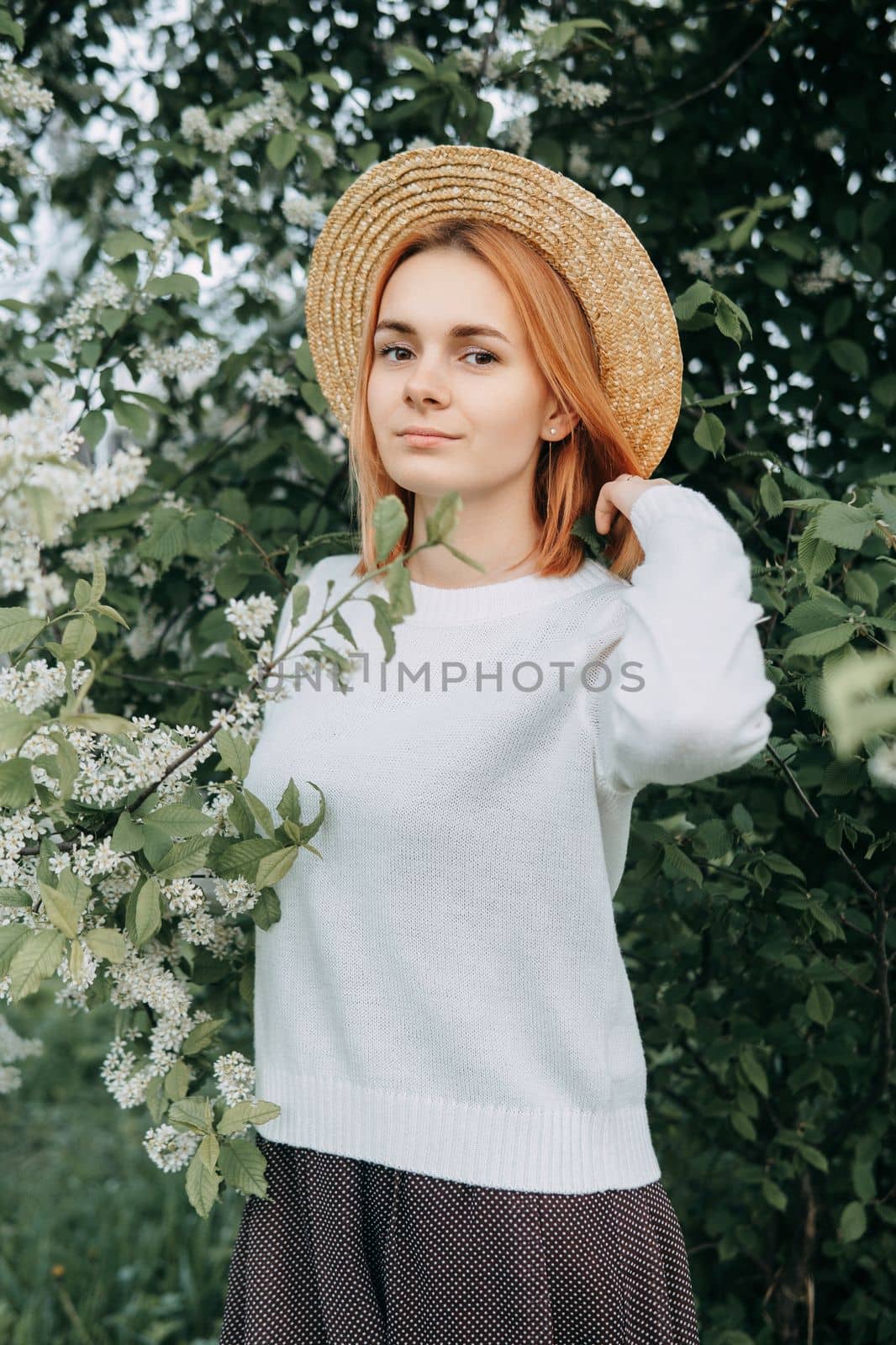 Portrait of a woman in a straw hat in a cherry blossom. Free outdoor recreation, spring blooming garden. by Annu1tochka