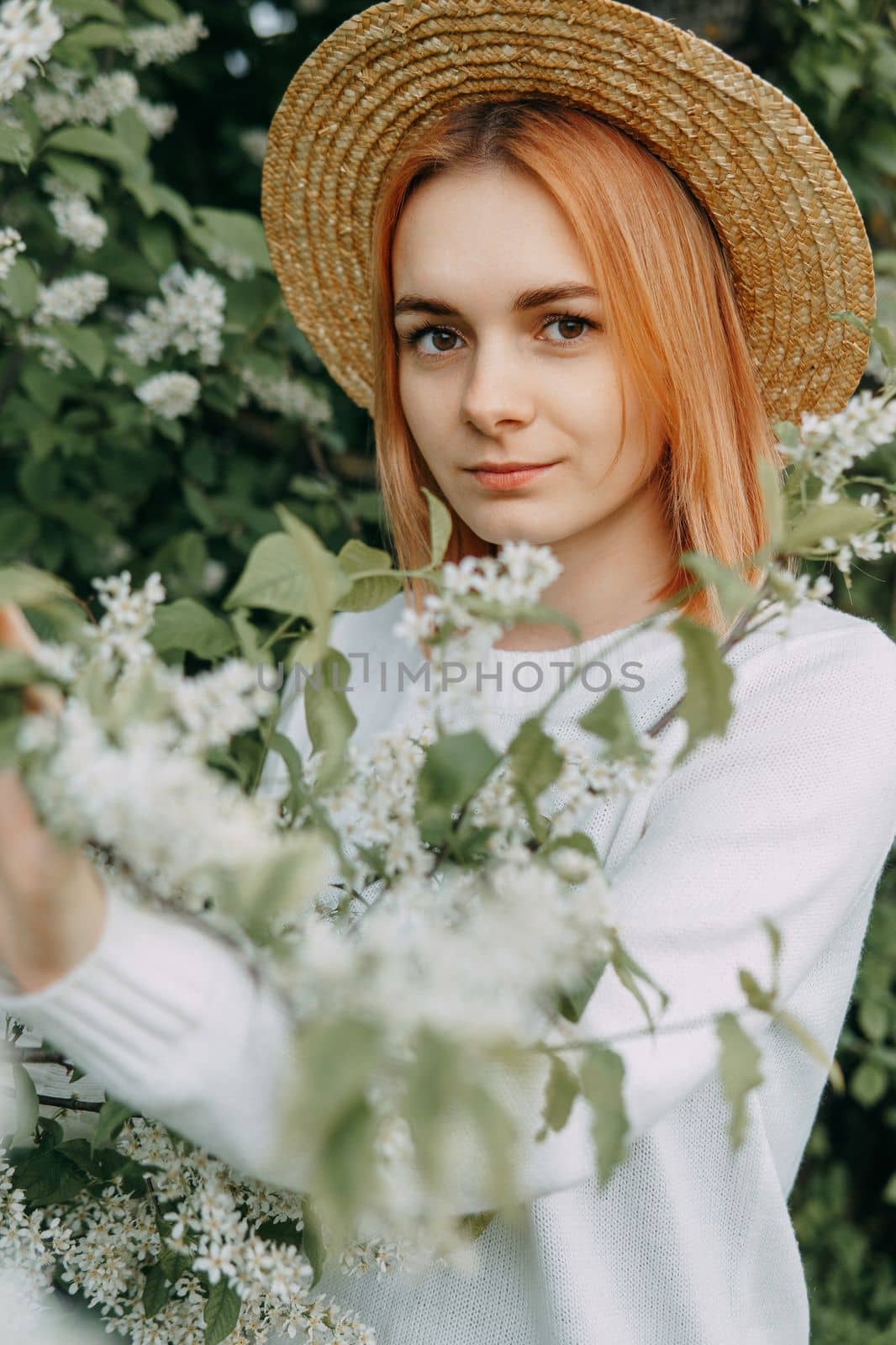 Portrait of a woman in a straw hat in a cherry blossom. Free outdoor recreation, spring blooming garden. by Annu1tochka