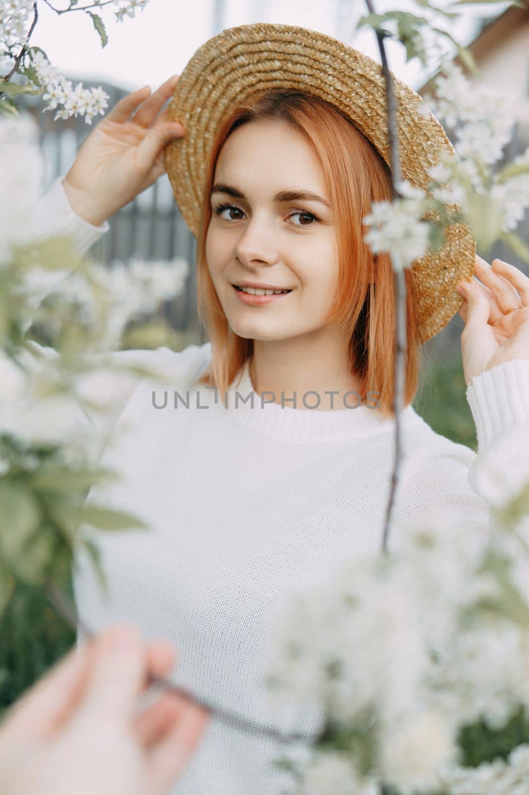 Portrait of a woman in a straw hat in a cherry blossom. Free outdoor recreation, spring blooming garden. by Annu1tochka