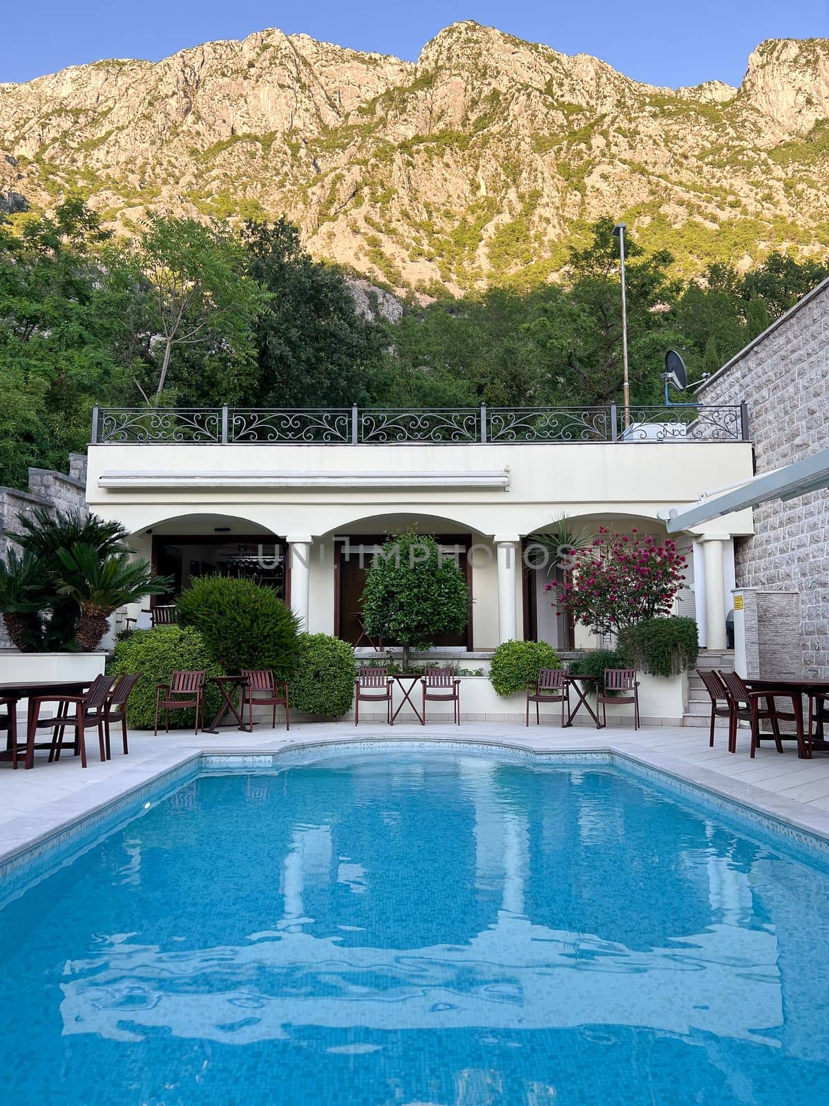Pool in the courtyard of the house at the foot of the mountains. High quality photo