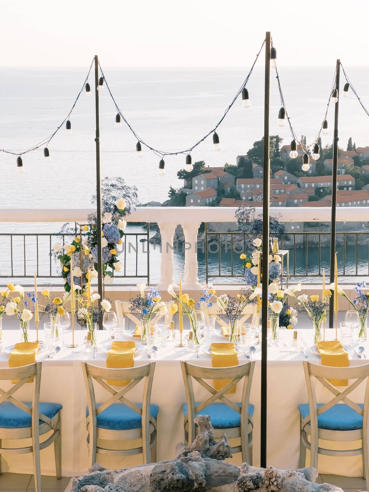 Set table on the terrace of a restaurant overlooking the island of Sveti Stefan. High quality photo