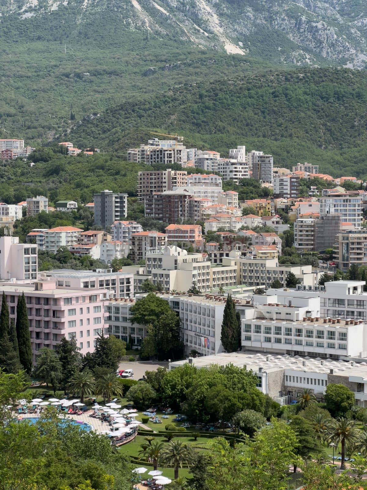 Modern high-rise buildings in Budva at the foot of the mountains. High quality photo