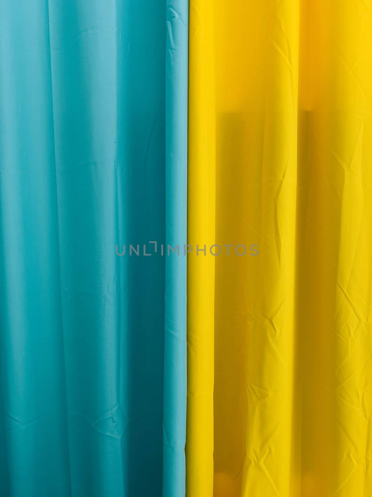 Blue and yellow textile curtains. Close-up by Nadtochiy