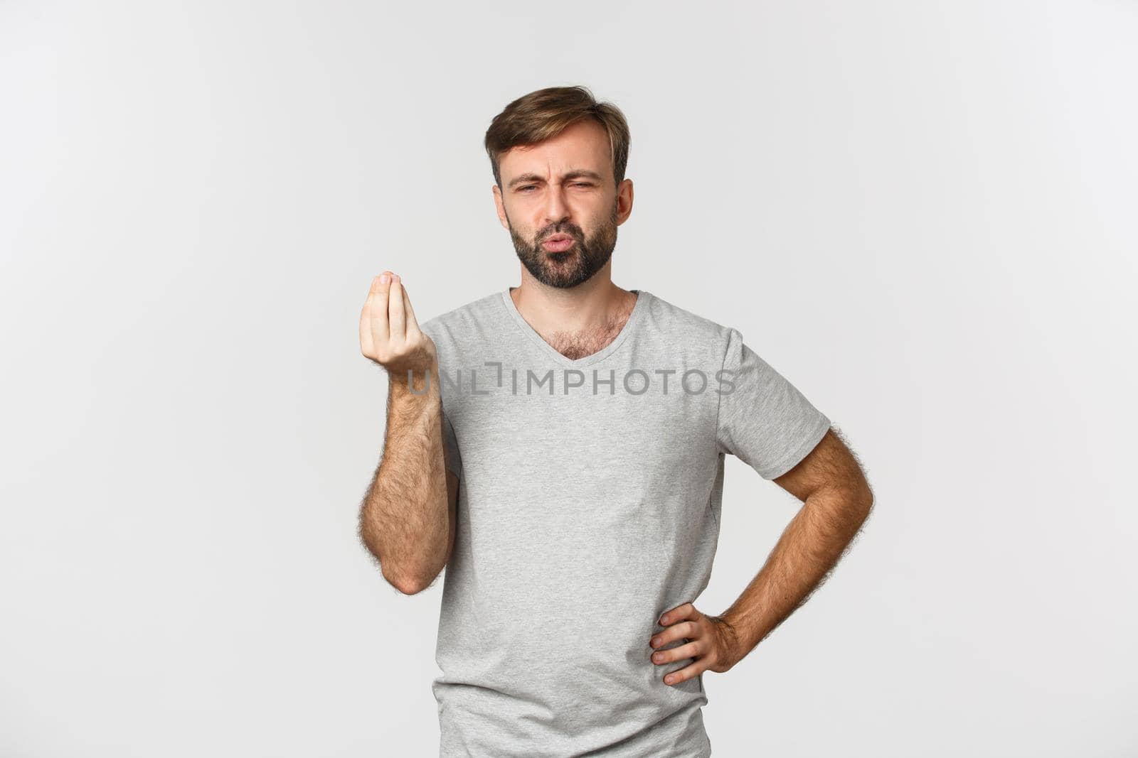 Image of handsome caucasian man showing chefs kiss sign and praising tasty food, pouting delighted, standing over white background by Benzoix