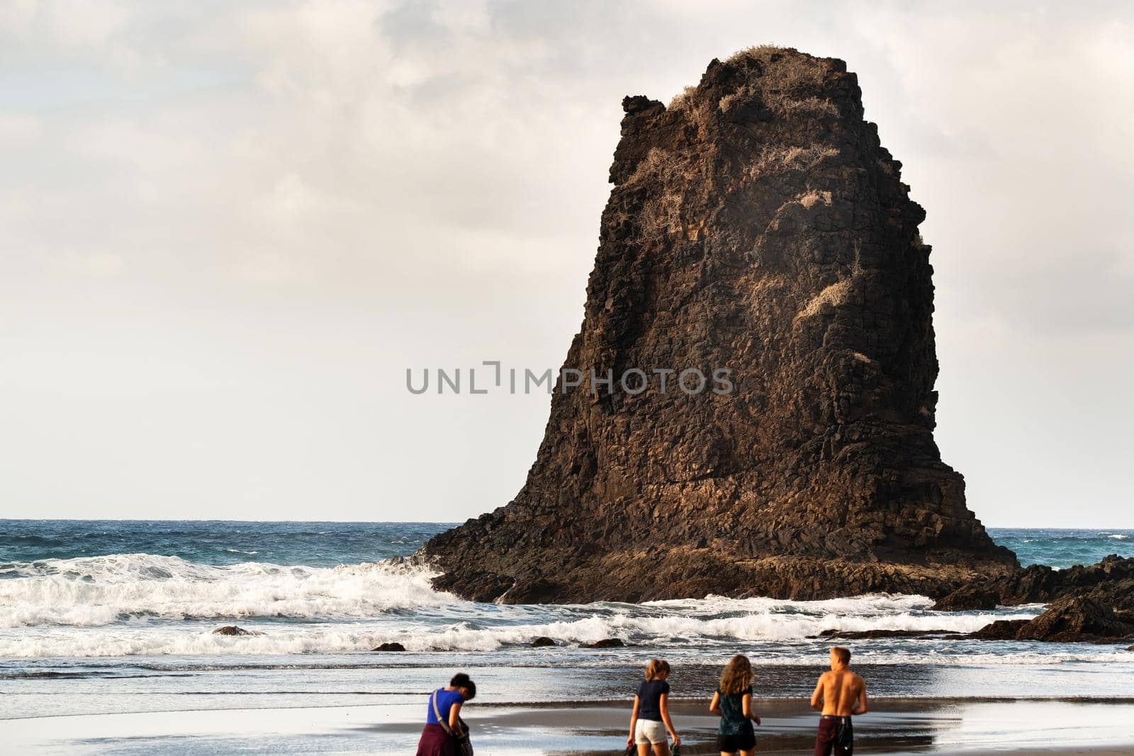 People on the sandy beach of Benijo on the island of Tenerife.Spain by Lobachad