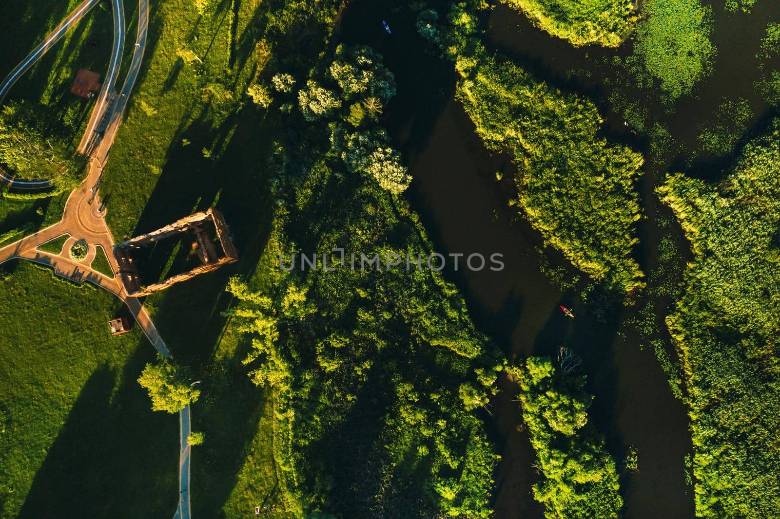 Top view of the ruins of an old mill in Loshitsky Park in Minsk and the Svisloch river at sunset.Beautiful nature of Belarus. by Lobachad