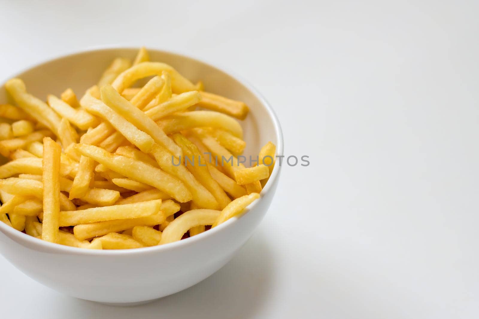 Bowl of french fries on a white background by magicbones