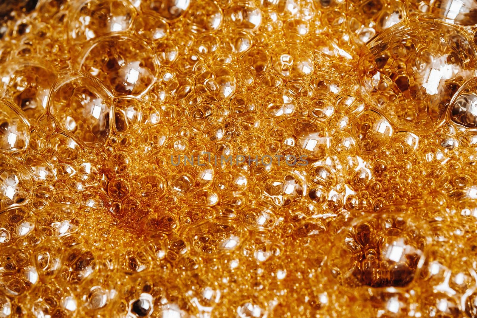 Preparation of sugar candies at home.A taste of our childhood.Background, sugar bubbles Texture.Boiling caramel sugar.