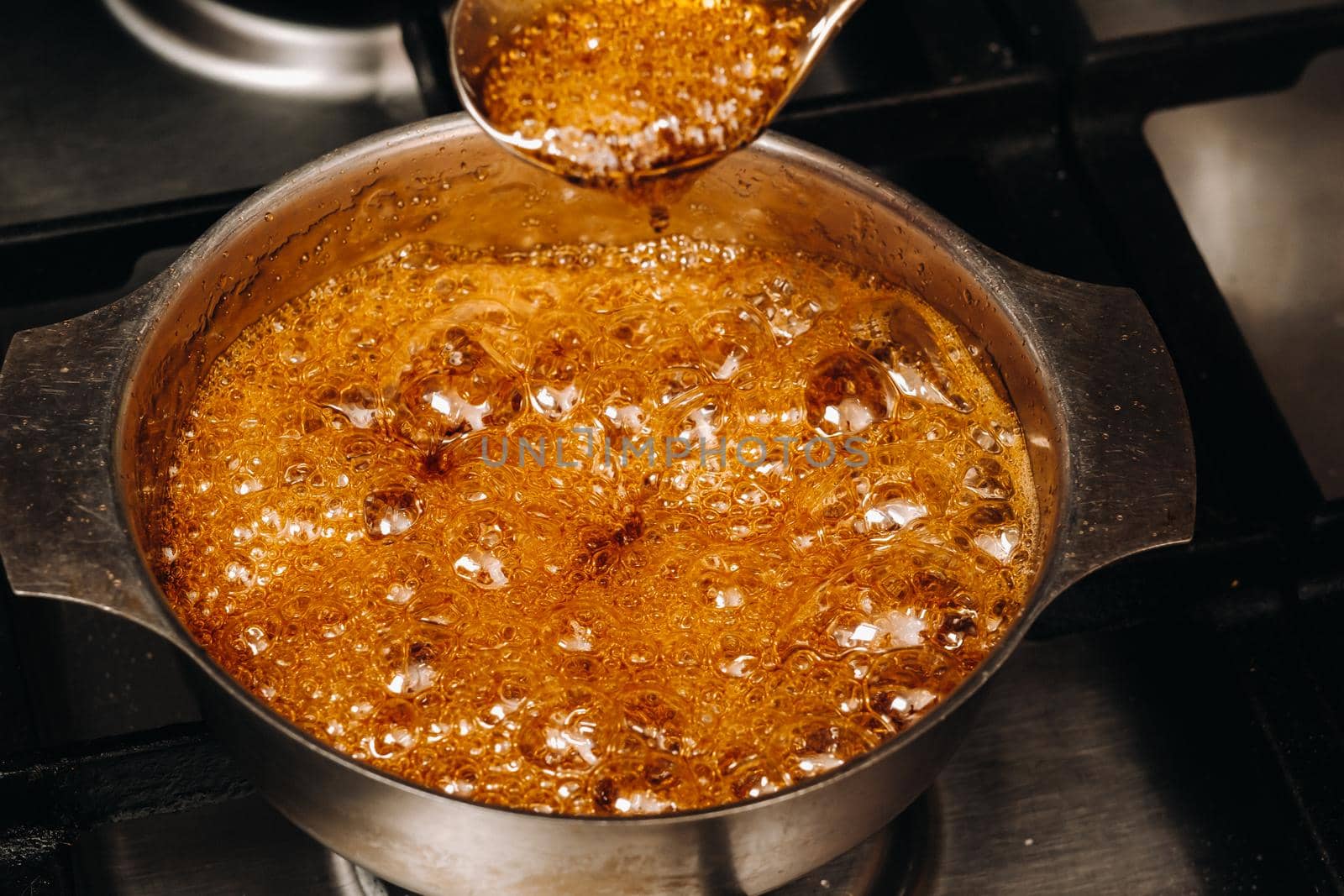 Preparation of sugar candies at home.A taste of our childhood.Rooster lollipops.Boiling Sugar caramel.