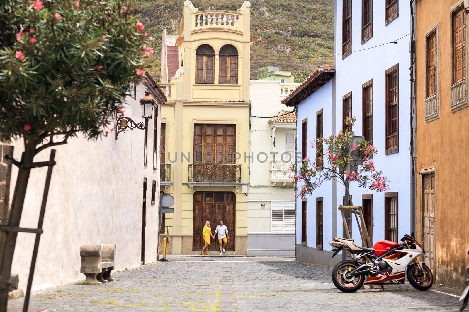 a modern married couple of lovers strolling in the old town of the island of Tenerife, a couple of lovers in the city of LA Laguna by Lobachad
