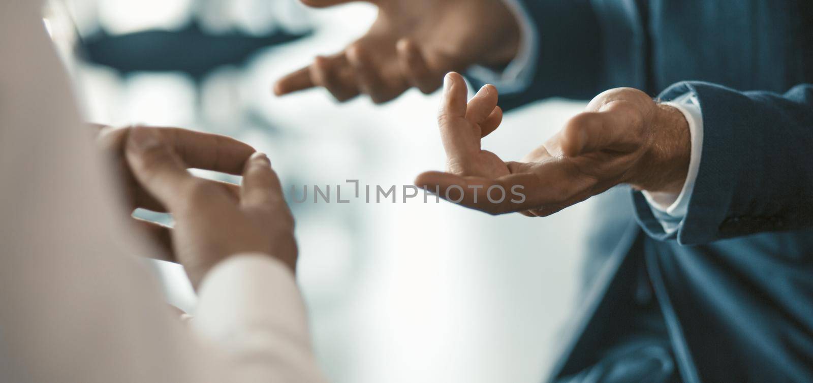 Gesturing of human hands. Office staff communicating. Business discussion concept. Close up shot. Toned image.
