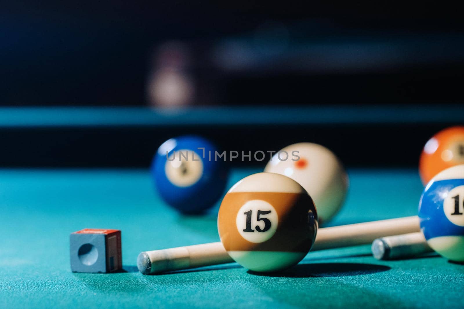 Billiard table with green surface and balls in the billiard club.Pool Game by Lobachad