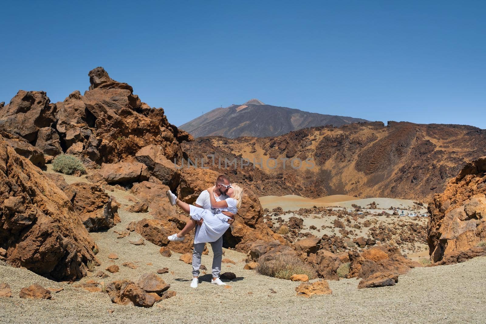 a man holds a girl in the crater of the Teide volcano.Tenerife, Canary Islands.