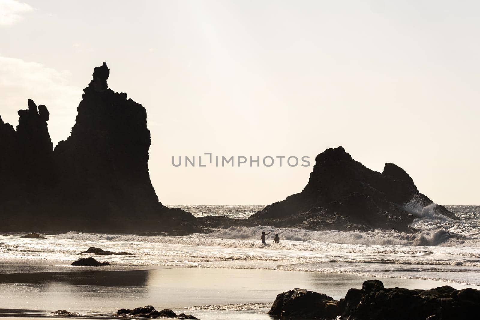 People on the sandy beach of Benijo on the island of Tenerife.Spain by Lobachad