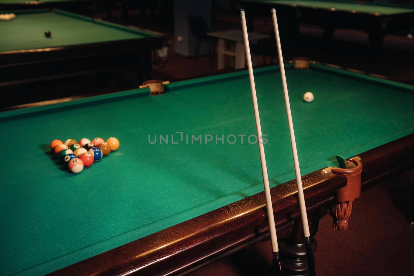 Billiard table with green surface and balls in the billiard club.Pool Game.