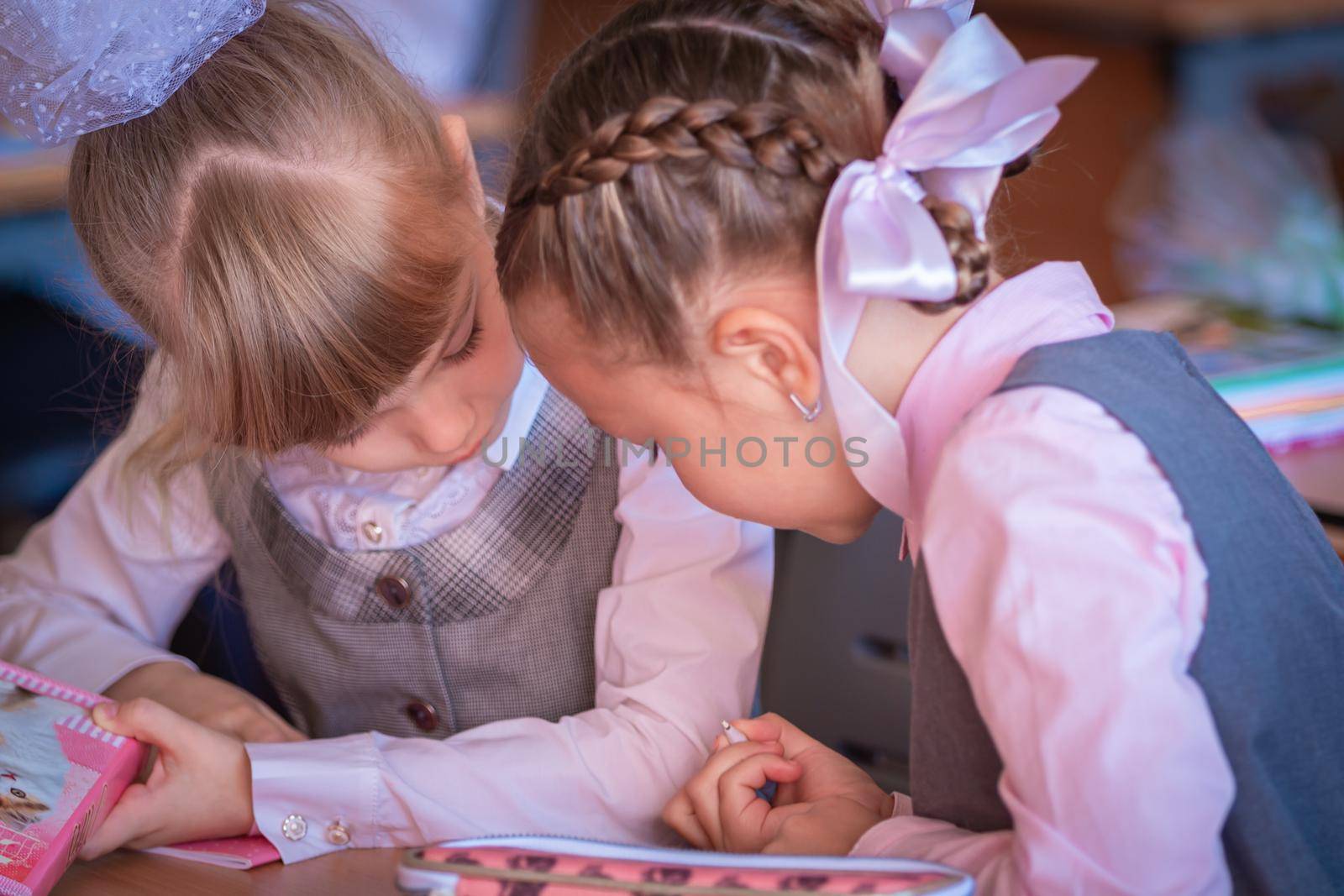 First graders sit at their desks and talk about a non-writing pen. First of September. School. First grade. Moscow, Russia, September 2, 2019