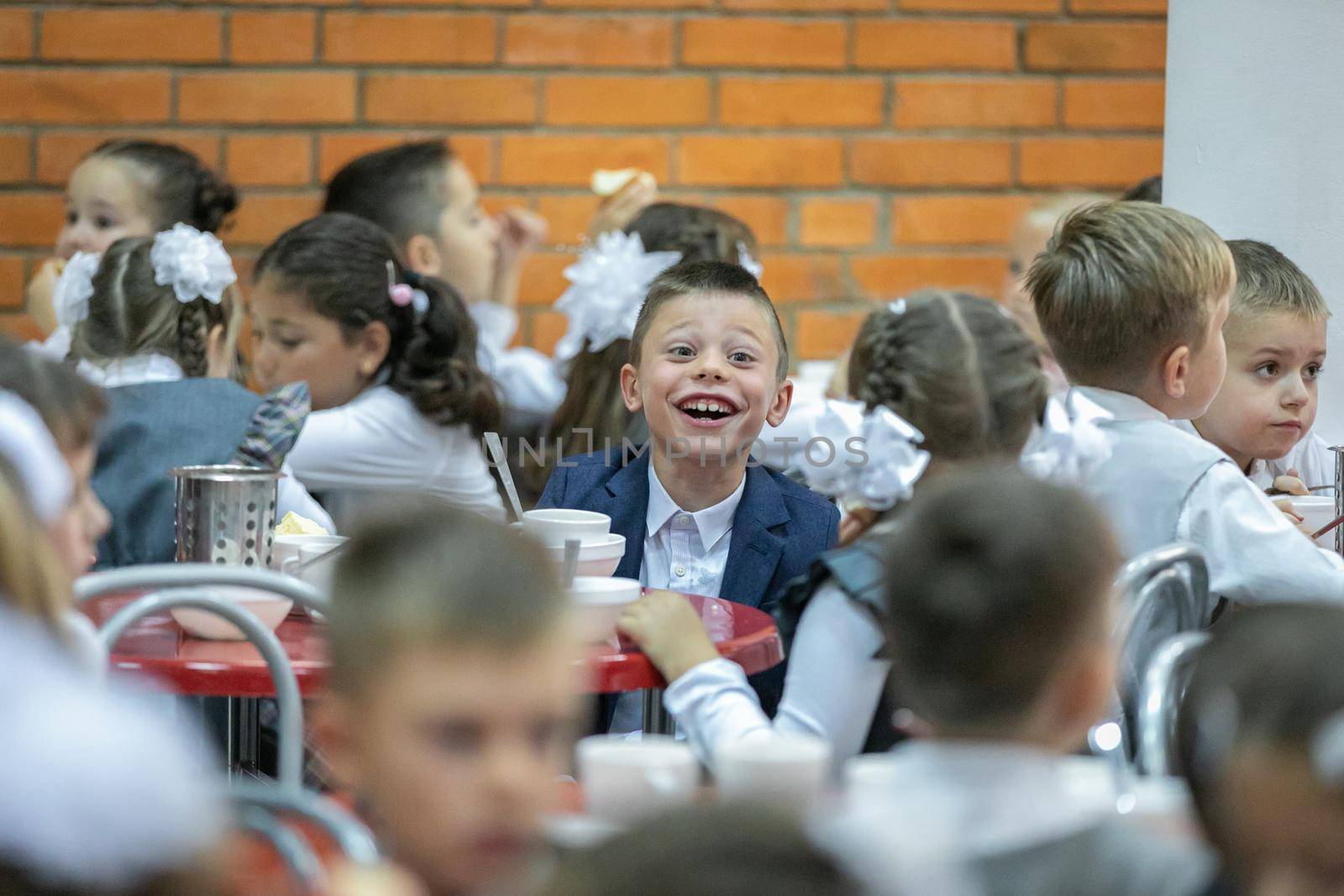 First graders eat in the school cafeteria. Lunch in the dining room on September 1st. Moscow, Russia, September 2, 2019