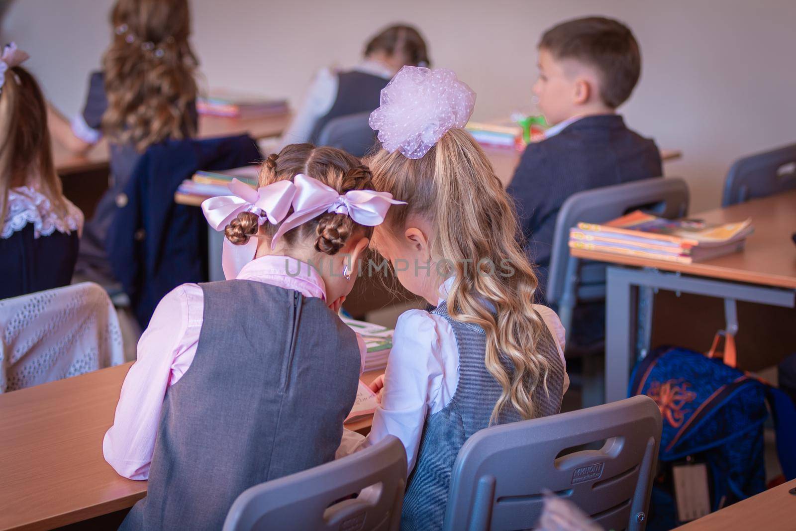 Children sit at their desks in class on September 1. First graders listen carefully to the teacher in the first lesson. Moscow, Russia, September 2, 2019