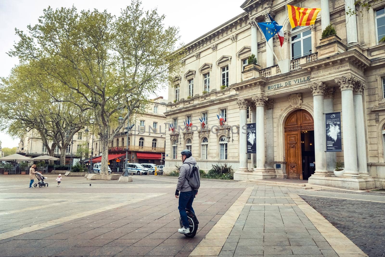 Avignon, France-April 6, 2019: Old Town Street and Hotel de Ville in the center of Avignon by Lobachad