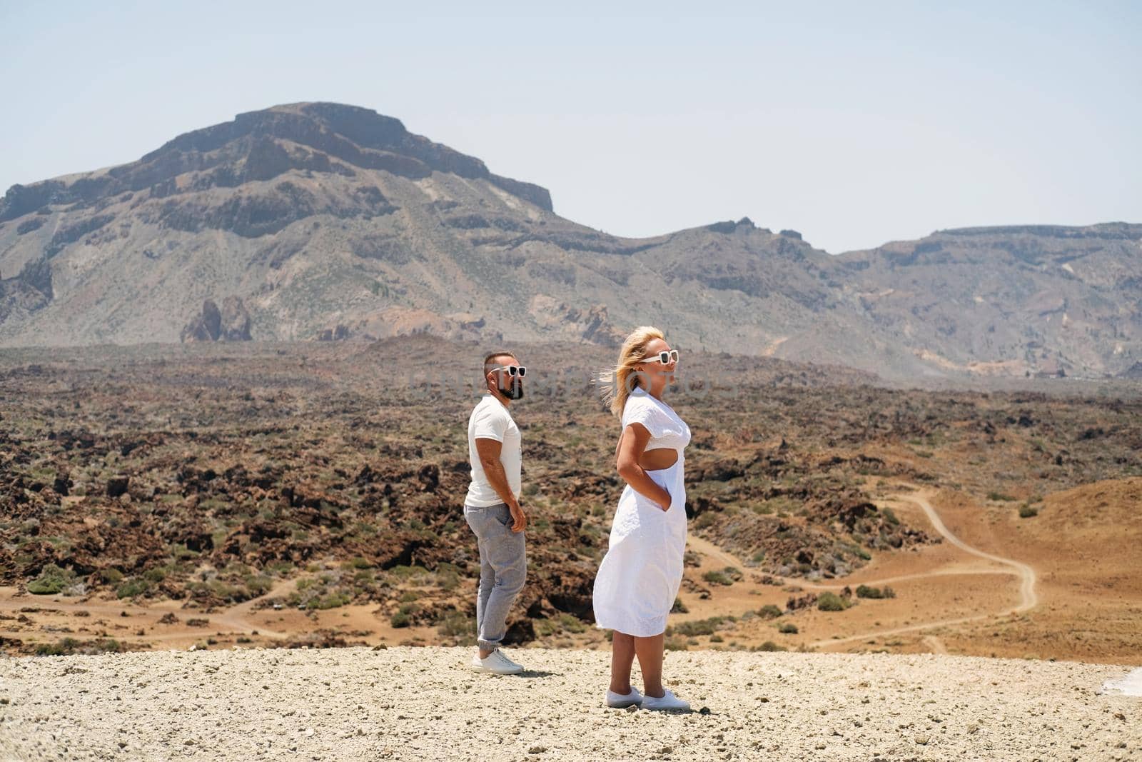 A couple in love stands in the crater of the Teide volcano.Tenerife, Canary Islands by Lobachad