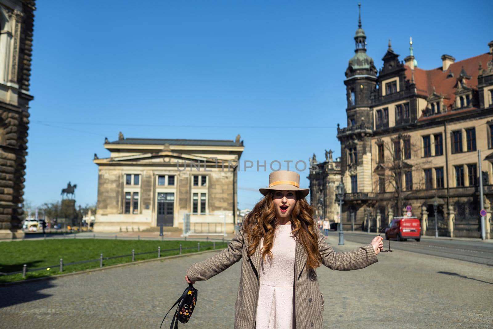 a girl in a coat and hat on a street in the city of Dresden. Saxon Switzerland, Germany.