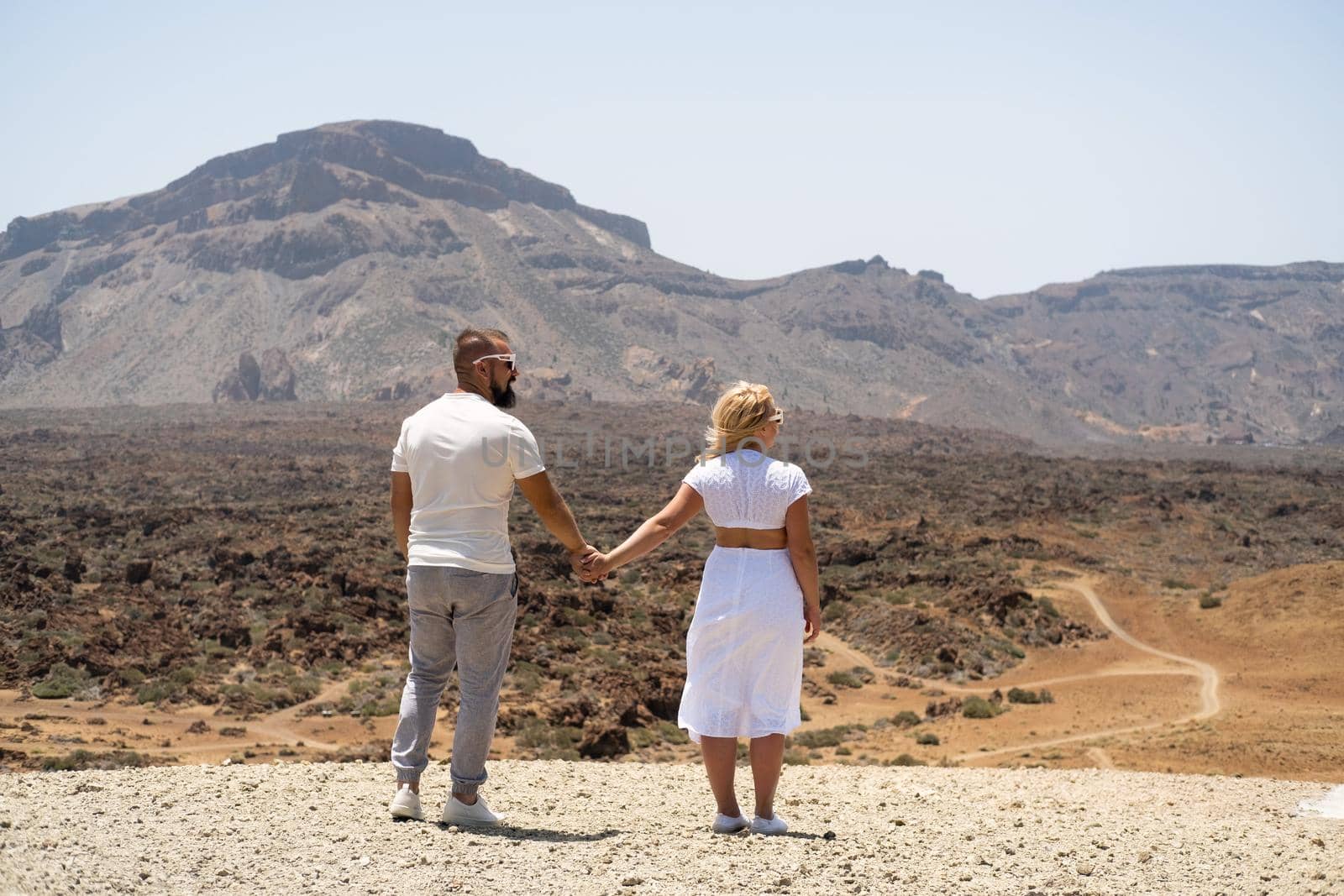 A couple in love hold hands in the crater of the Teide volcano.Tenerife, Canary Islands.