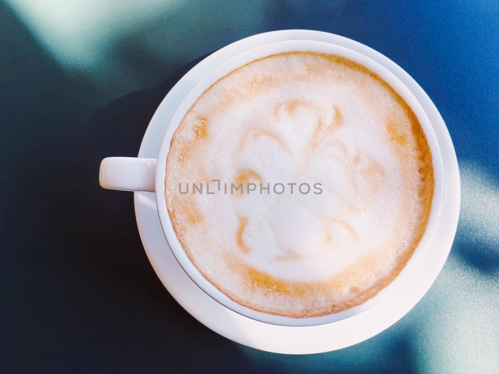 Cappuccino in summer cafe outdoors by Anneleven