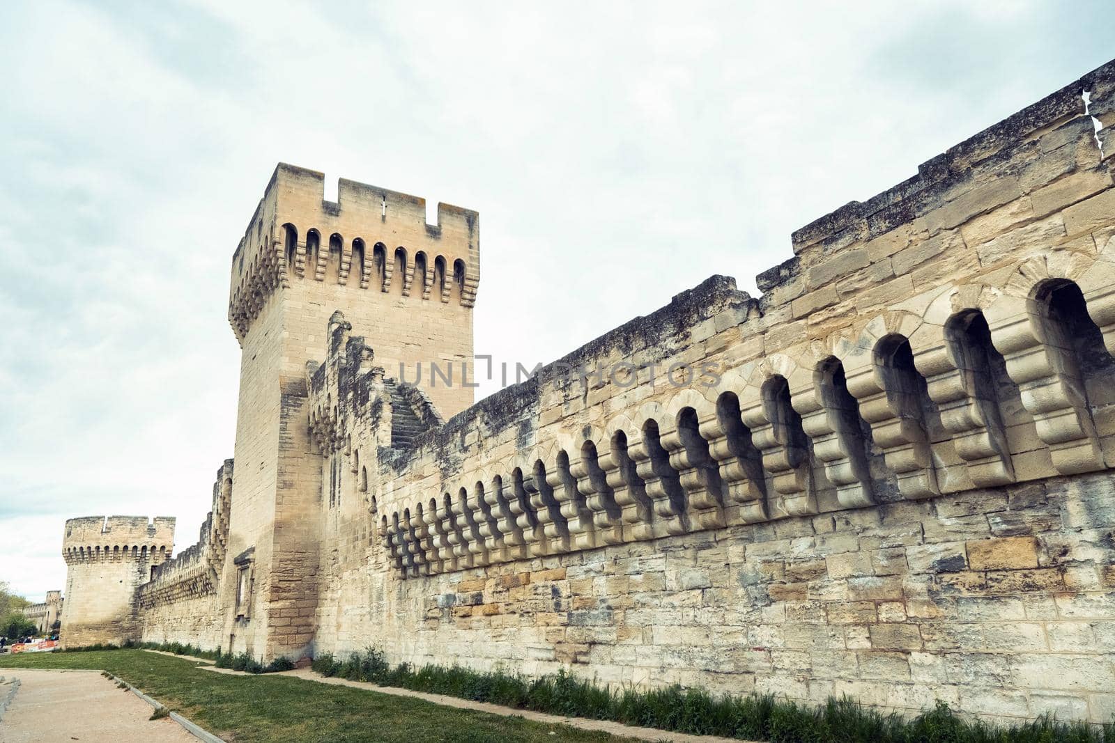 The fortress wall near the Palace of the Popes in the old town of Avignon.France by Lobachad