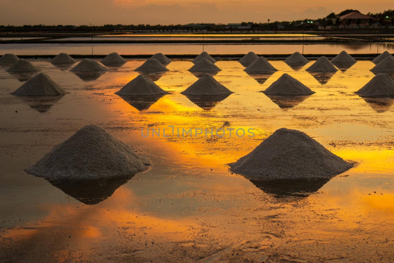 Salt in the salt fields in the evening During the shoveling of salt into the pile before transporting to the store.