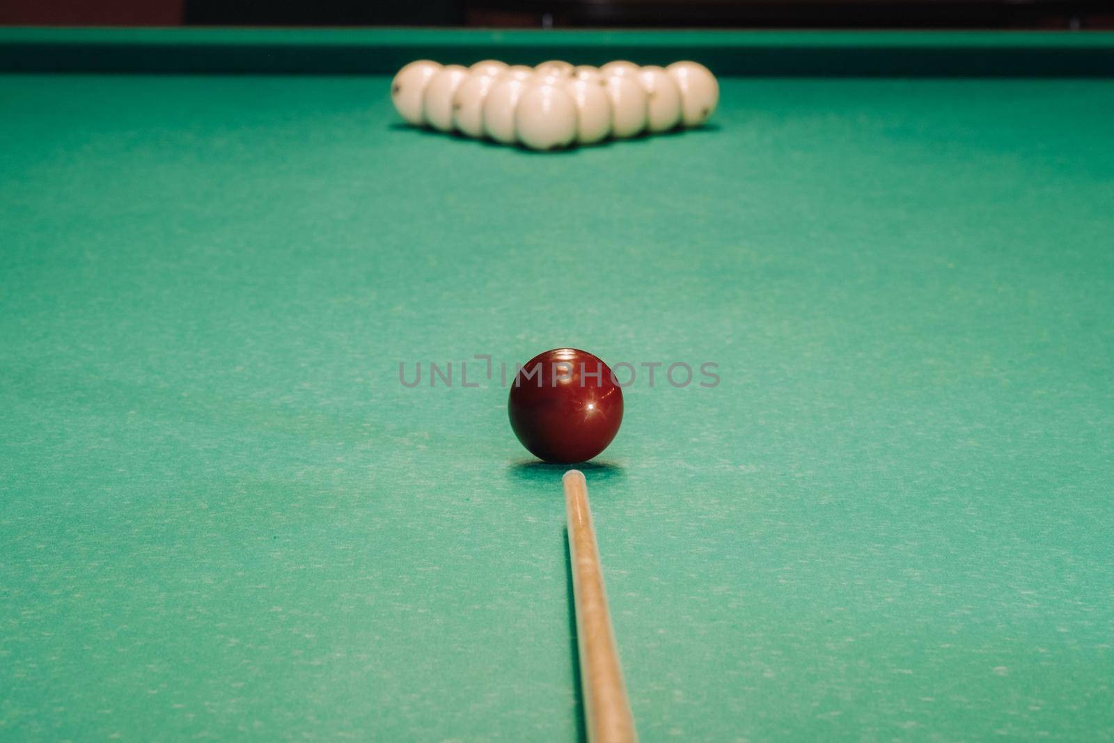 Start of the game of billiards on the green table.The balls are arranged in a triangle on the table.