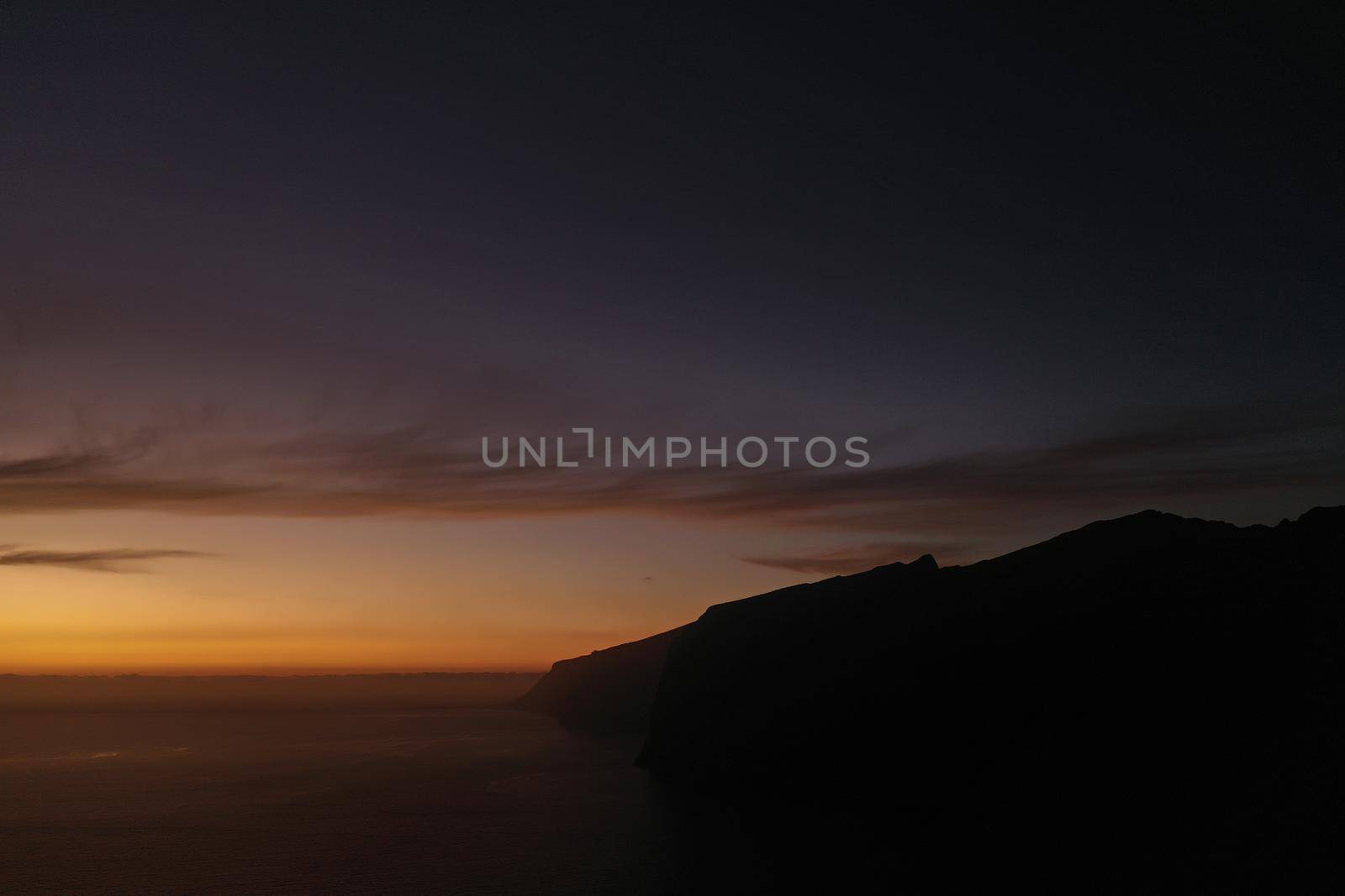 Aerial panorama of Acantilados de Los Gigantes Cliffs of the Giants at sunset, Tenerife, Canary islands, Spain. by Lobachad