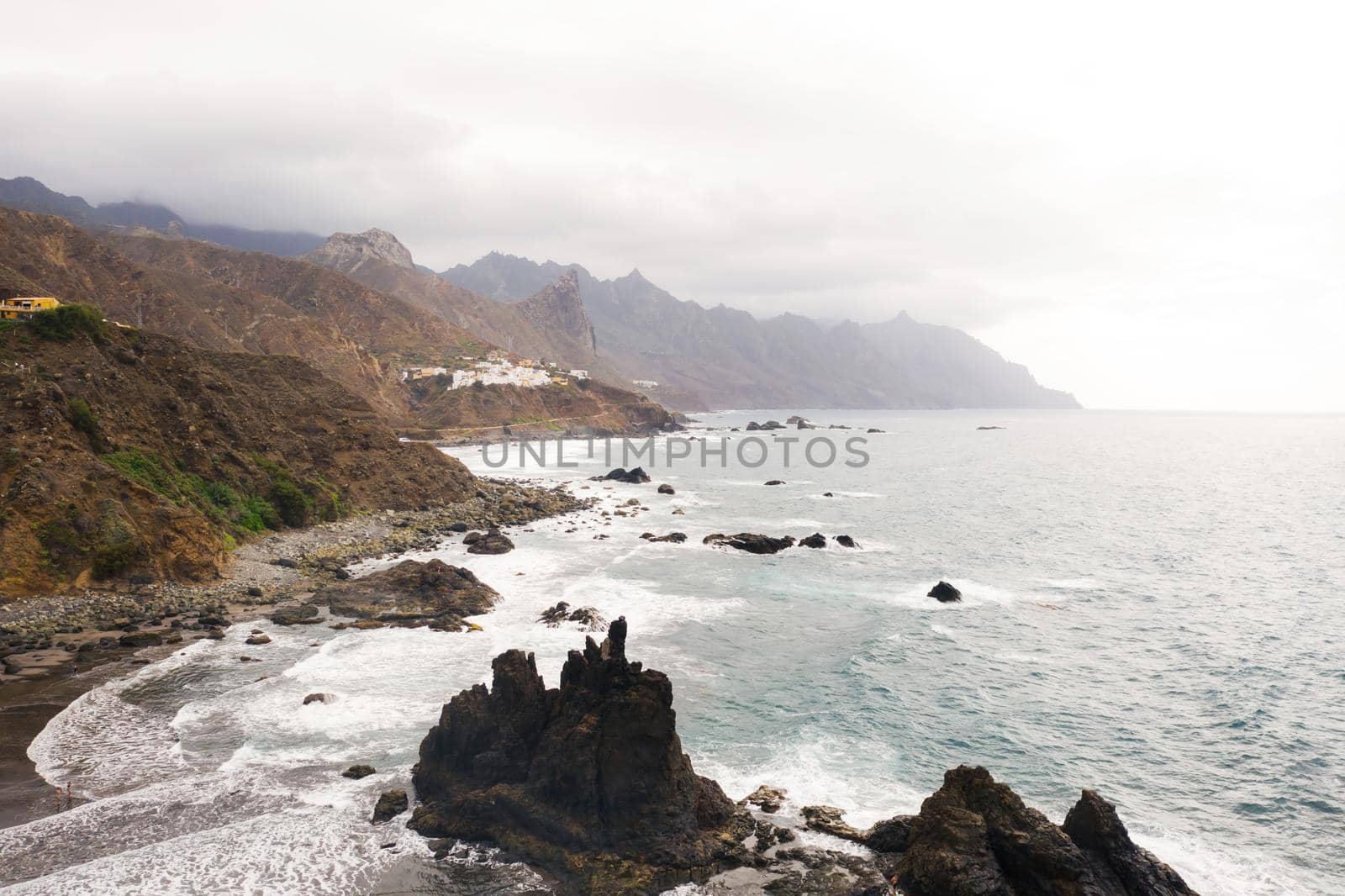 Rough rocky cliffs in the North of Tenerife. Beautiful Benijo beach in the Canary Islands. Rocks, volcanic rocks, Atlantic ocean.