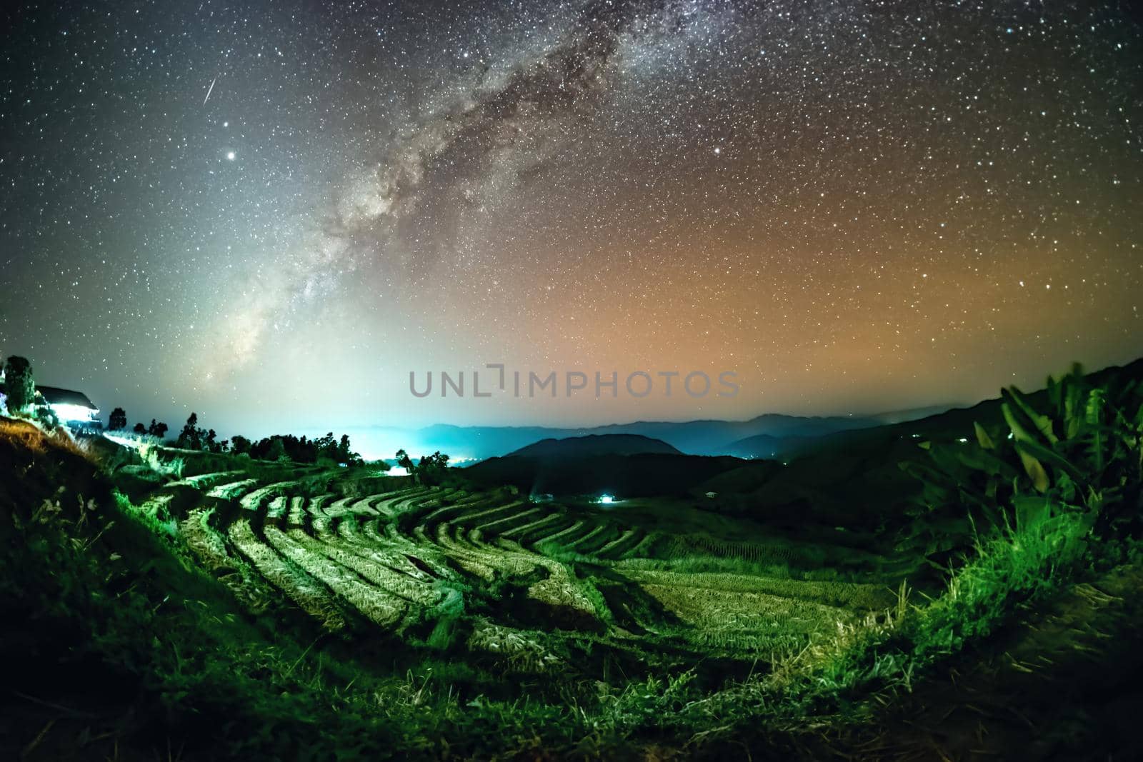 Milky Way and Zodiac Light on the rice field at Ban Pa Bong Piang Jomthong, Chiang Mai, Thailand.