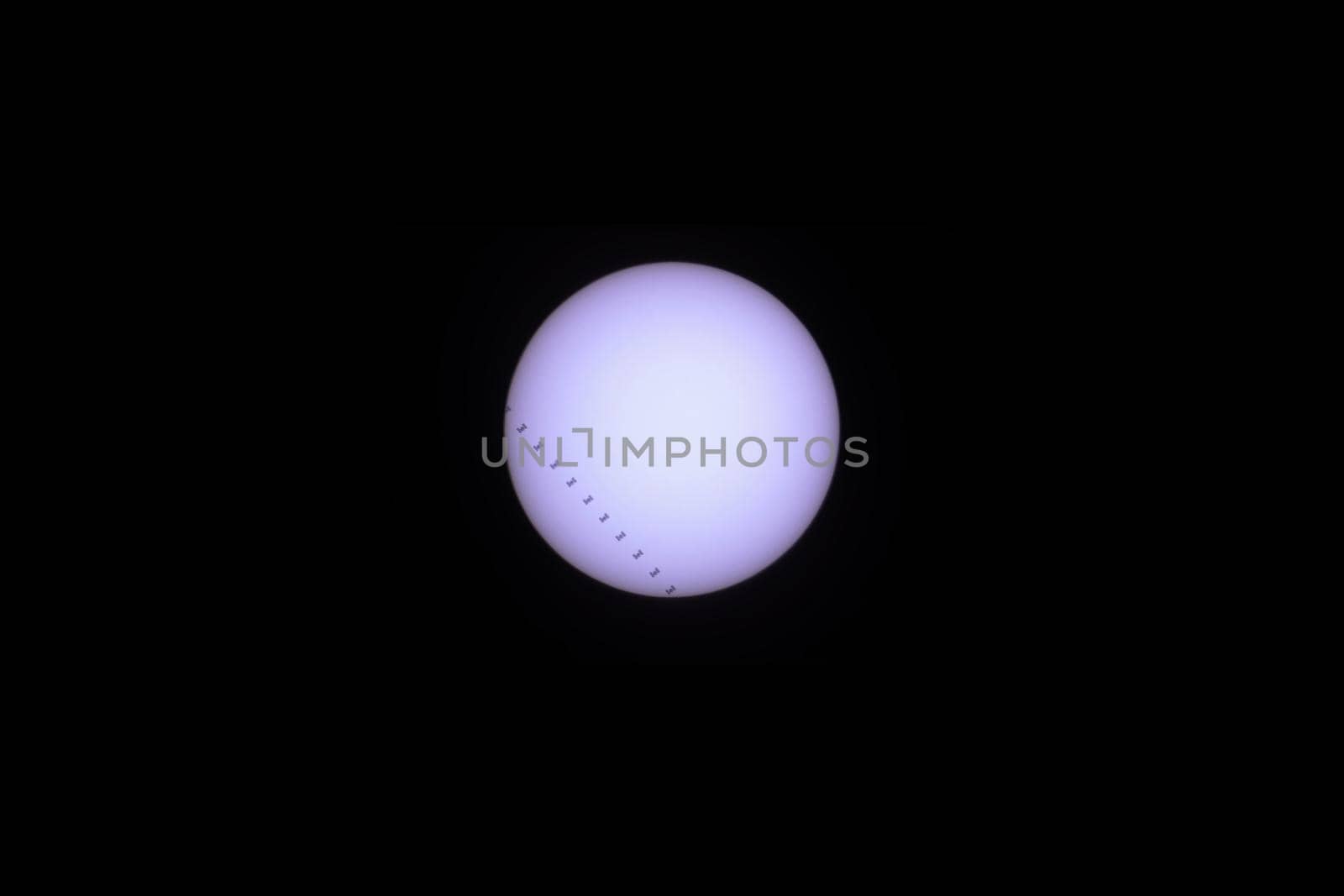 Telescopic view of the Sun as the International Space Station (ISS) transits . 11 frame composit