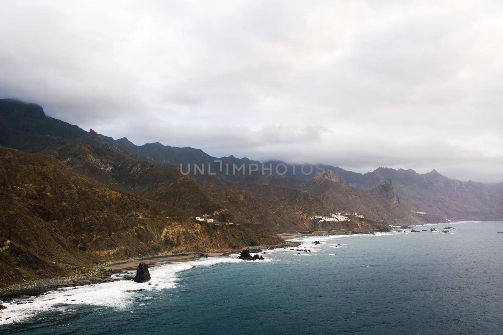Rough rocky cliffs in the North of Tenerife. Beautiful Benijo beach in the Canary Islands. Rocks, volcanic rocks, Atlantic ocean.