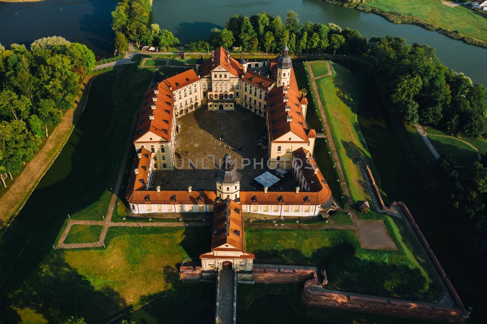 Aerial photo Nesvizh castle in autumn evening, Belarus Minsk, top view.