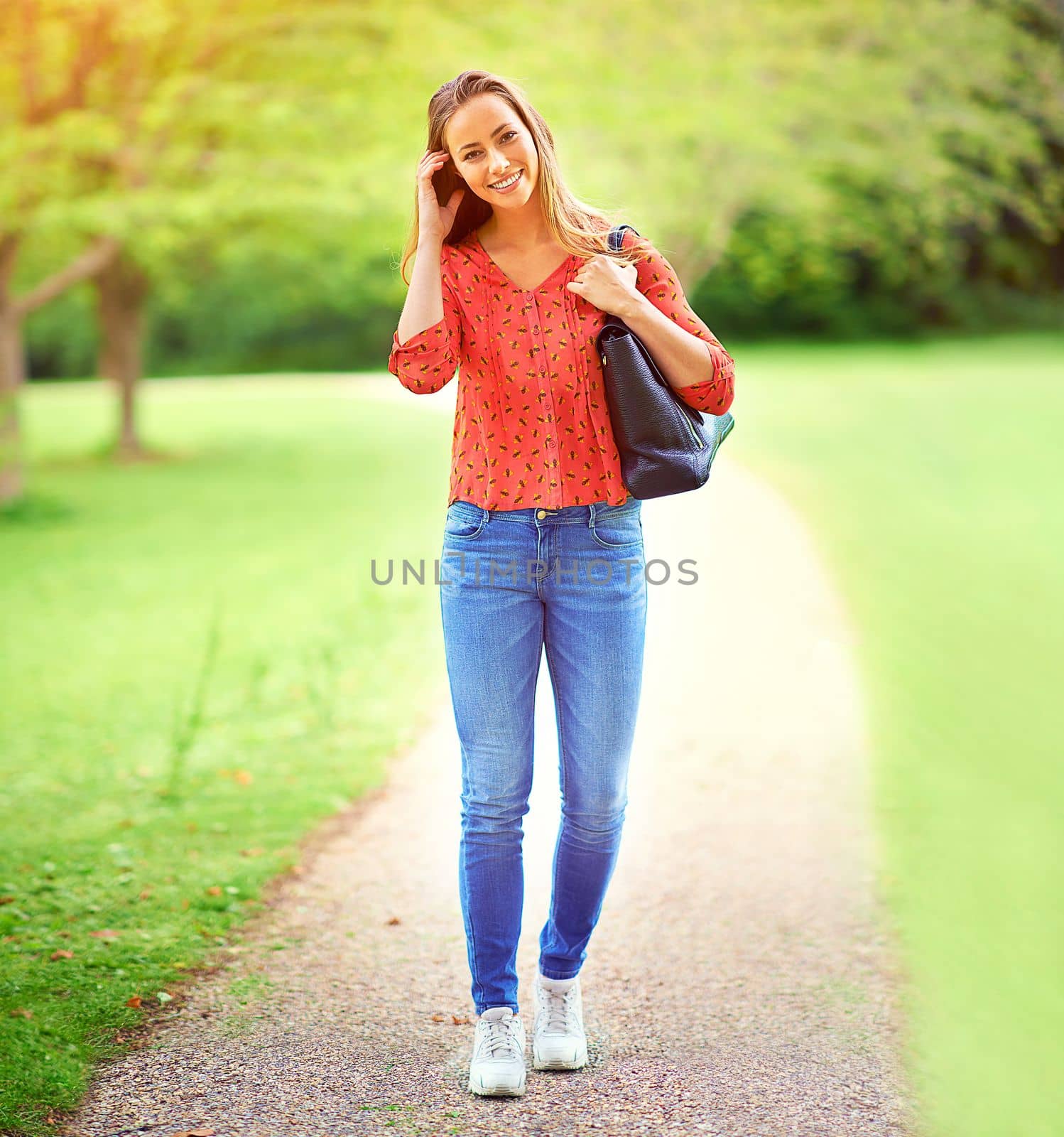 Being in the outdoors always puts a smile on my face. a young woman on a walk through the park