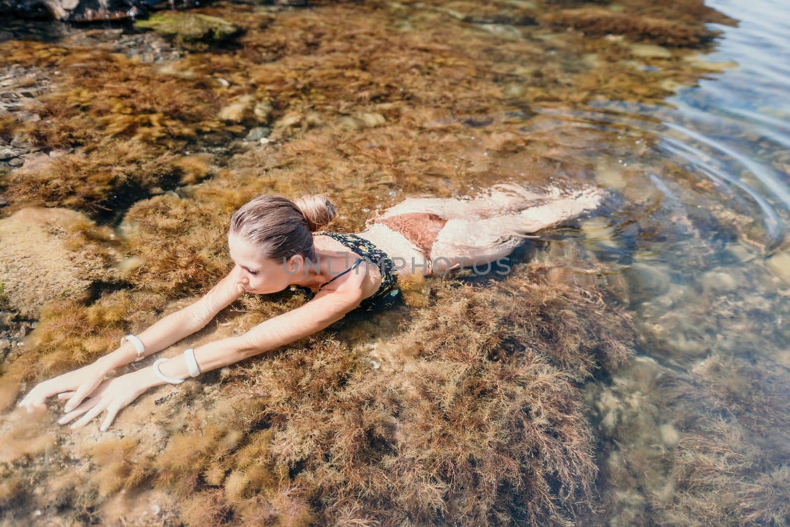 Woman travel sea. Happy tourist enjoy taking picture outdoors for memories. Woman traveler swim in the sea bay with mountains, sharing travel adventure journey by panophotograph