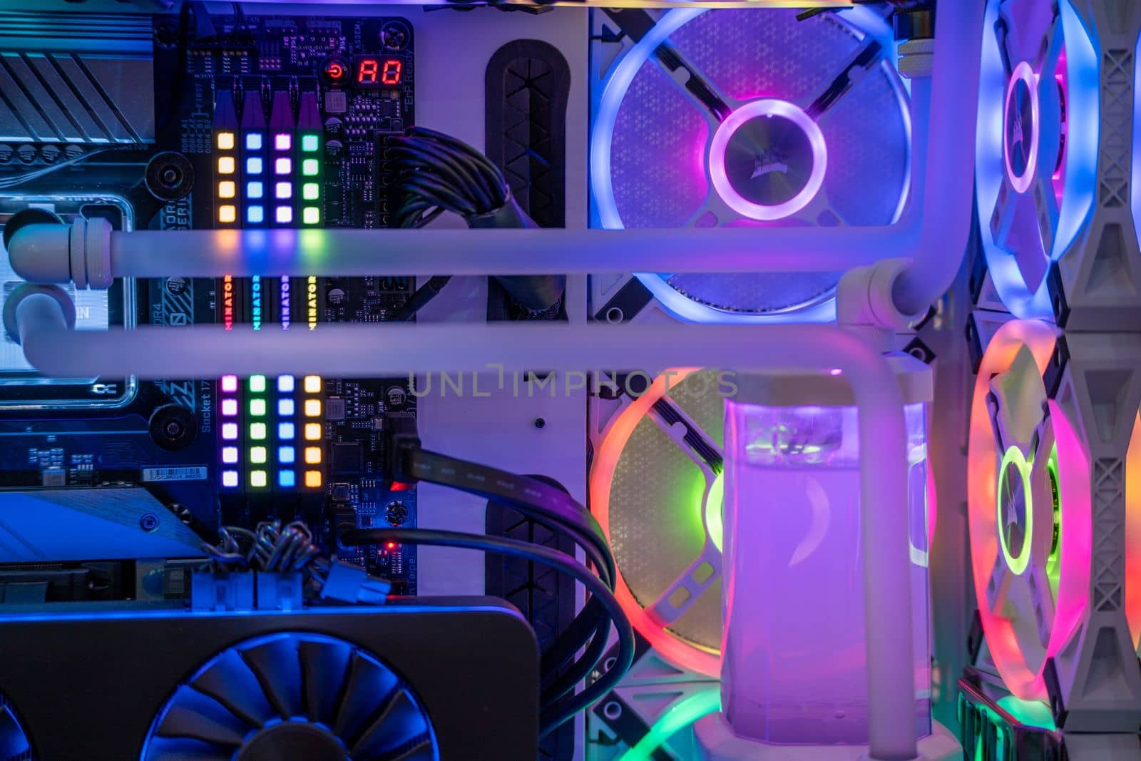 shot of overclocked CPU computer cabinet with water liquid cooled processors and RGB red green blue lighting with metal pipes running India