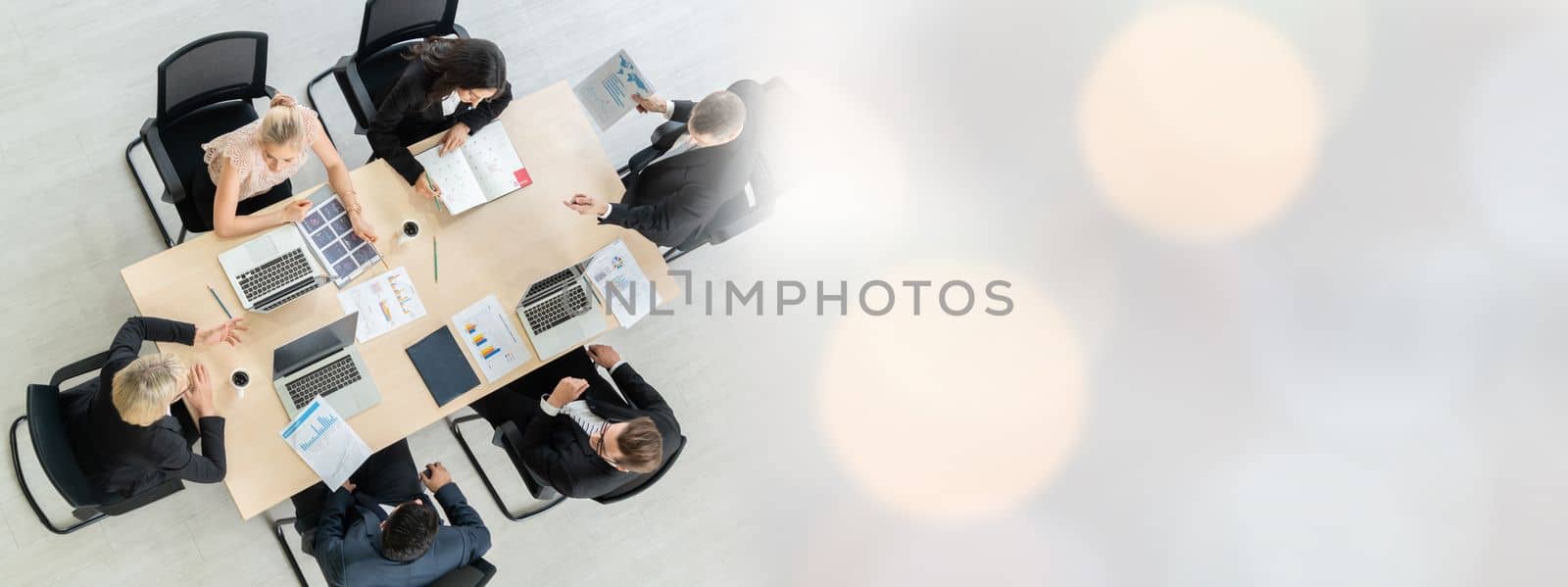 Business people group meeting shot from top widen view in office . Profession businesswomen, businessmen and office workers working in team conference with project planning document on meeting table .