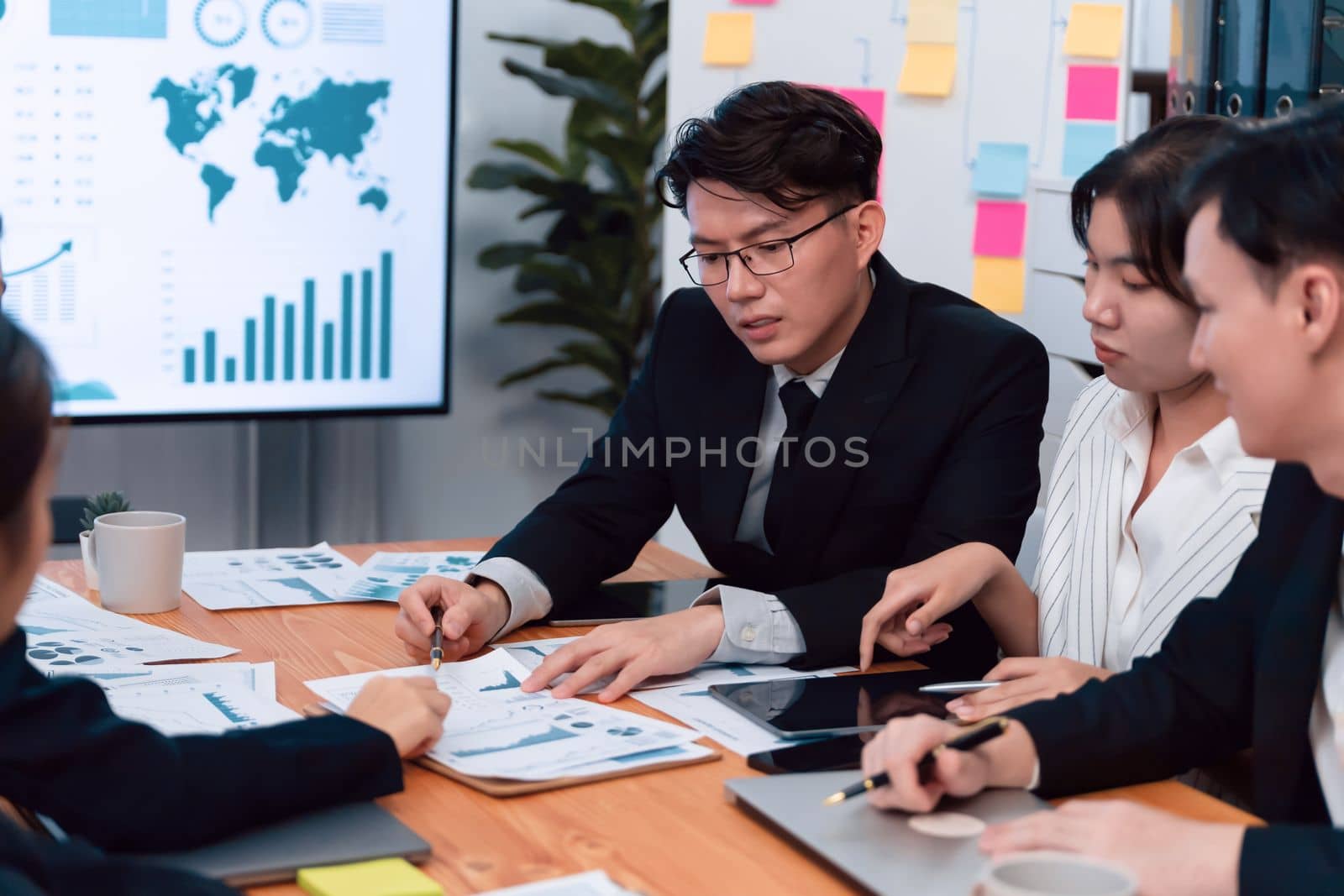 Business team of financial data analysis meeting with business intelligence, report paper and dashboard on laptop for marketing strategy. Business people working together to promote harmony in office.