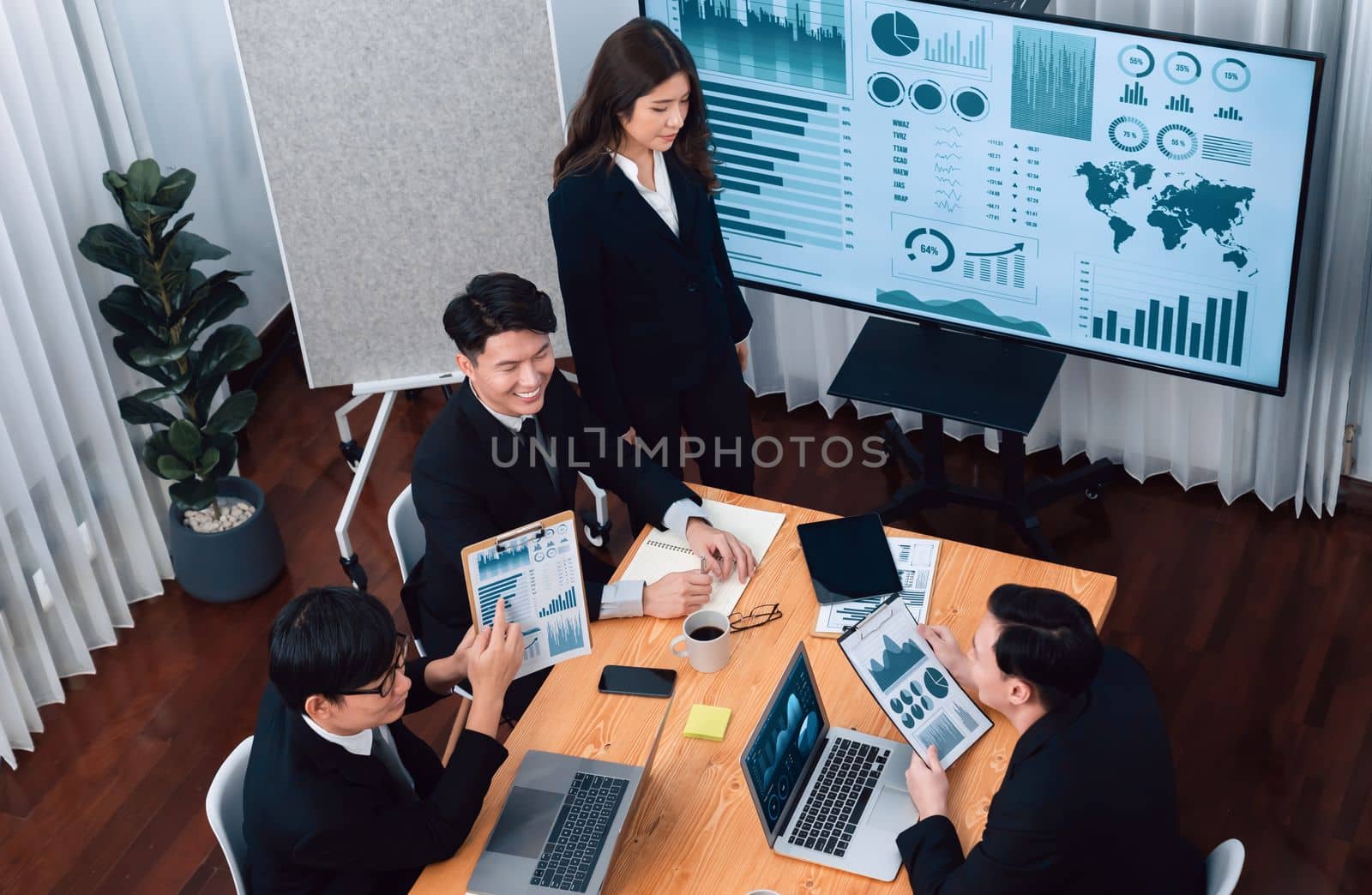 Confidence and young asian businessman give presentation to promote harmony. by biancoblue
