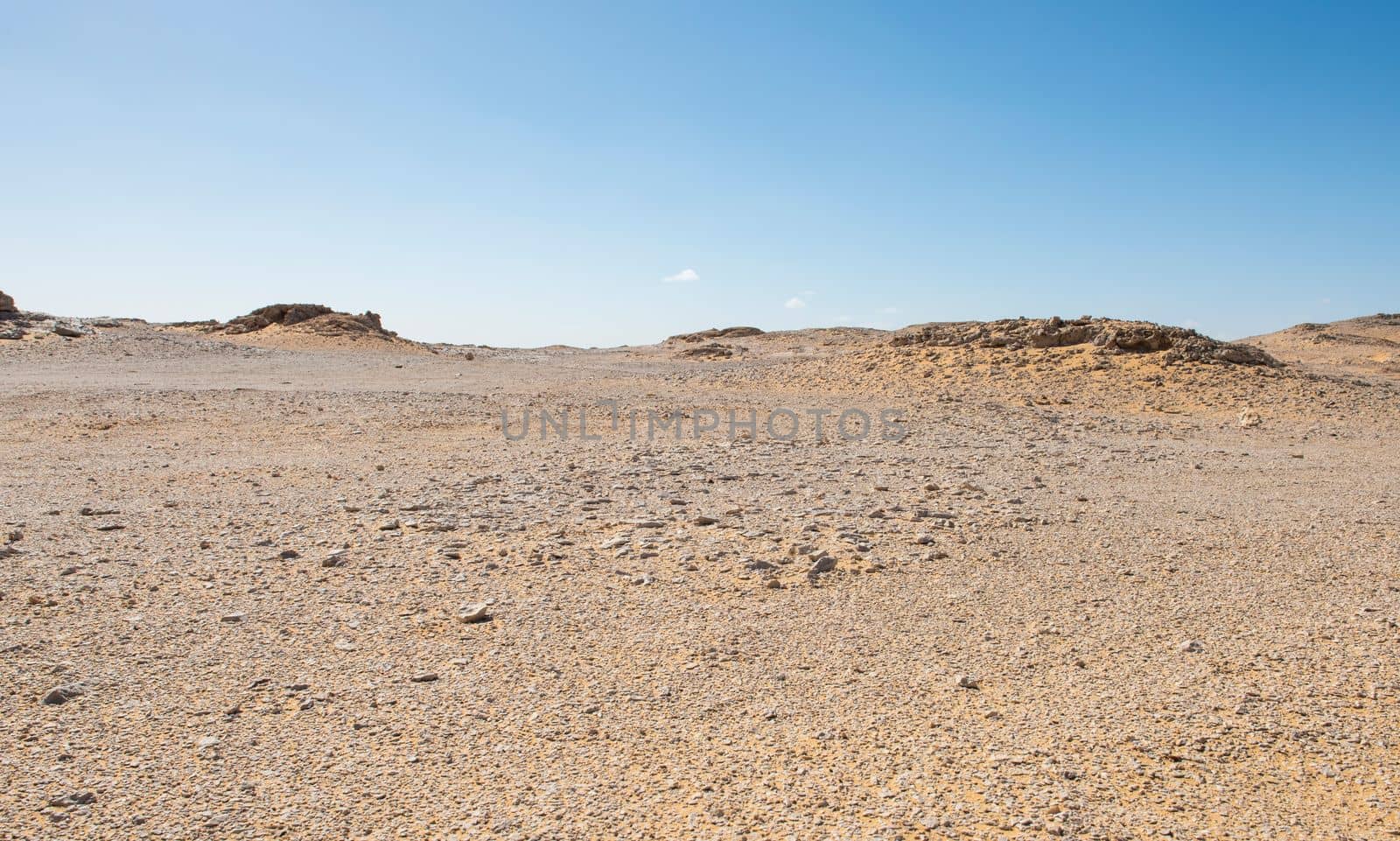 Barren desert landscape in hot climate with rocky scenery by paulvinten