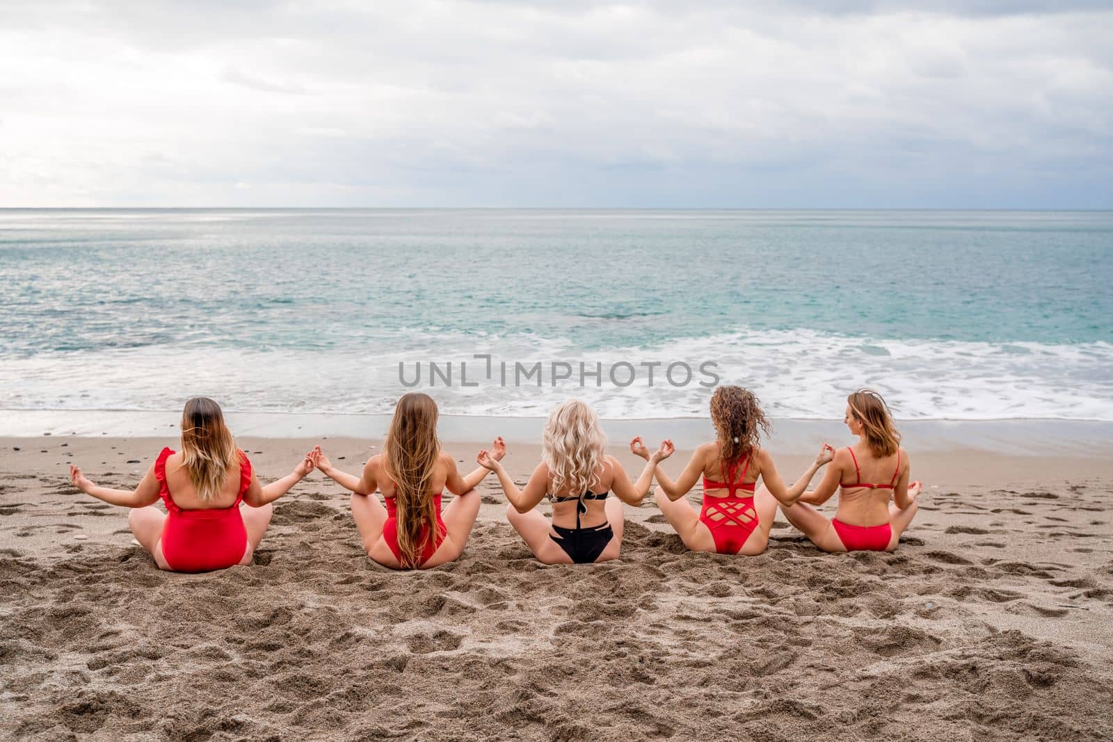Big happy family or group of five friends is having fun against sunset beach. Beach holidays concept