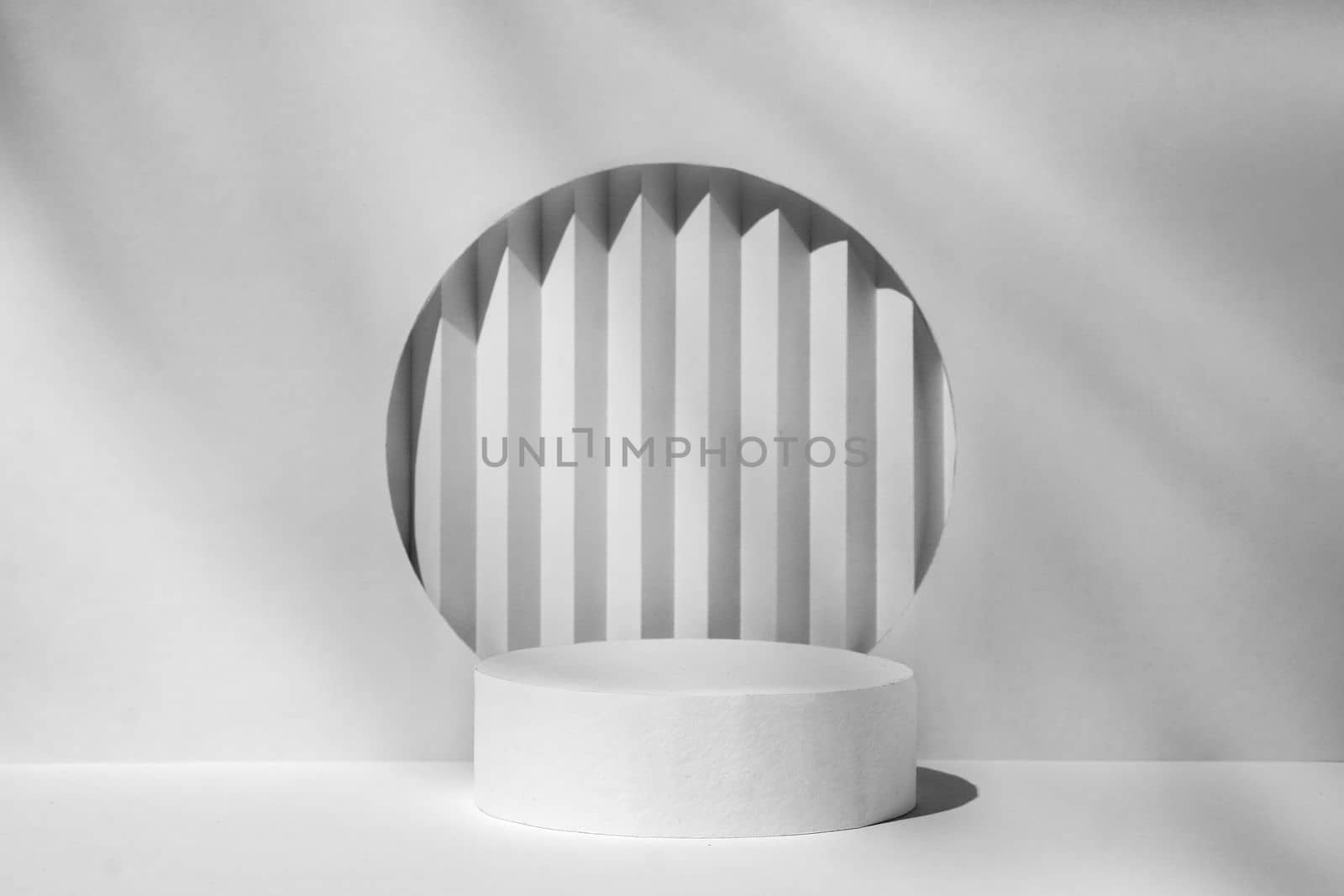 Geometric background with a podium in shades of gray to demonstrate the display of a product or cosmetics. Minimal interior mockup. High quality photo