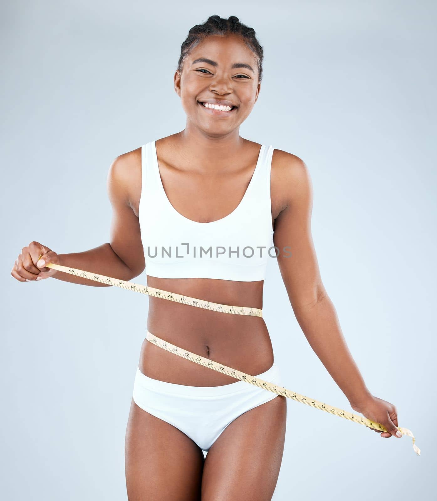 When you take care of your body, it shows. Studio shot of a fit young woman measuring her waist