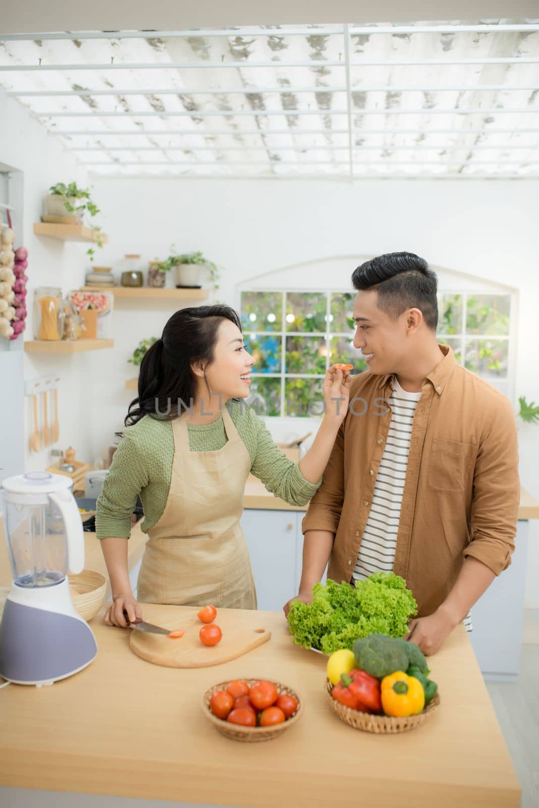 Attractive couple is cooking on kitchen.