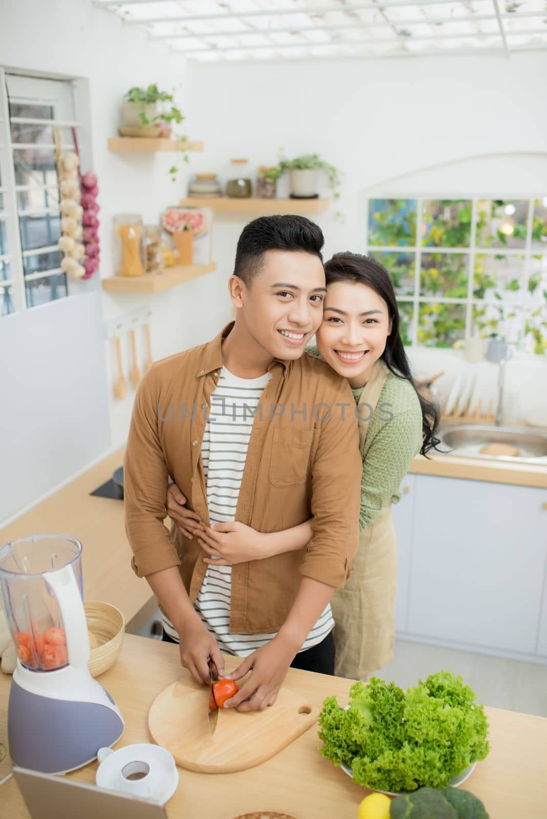 Young Asian couple. Standing cooking in the kitchen. 